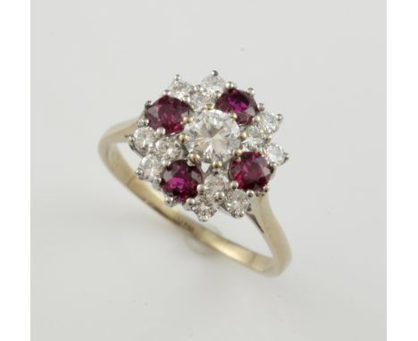  Vintage ruby and diamond cluster ring, central round brilliant cut diamond, estimated weight 0.42 carat, surrounded by four 