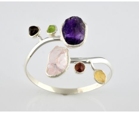 Contemporary rough stone twist bangle, set with large rough cut rose quartz and amethyst, with smaller peridot, citrine, smok