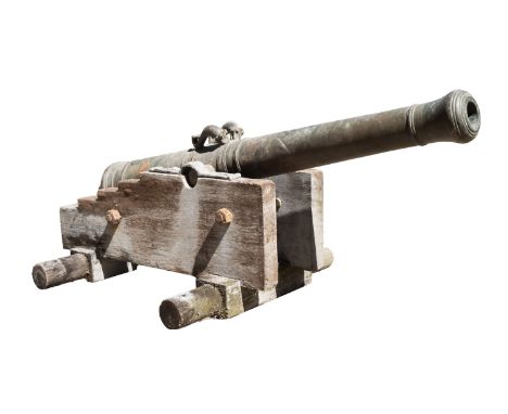 An 18th Century Continental bronze Cannon, having a four stage barrel with flared muzzle, dolphin lifting bars and plain trun