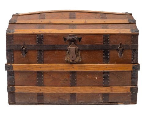 A 20th Century metal bound domed travel trunk. of plank construction with lined interior, 53cm high, 81cm wide, 46cm deep.