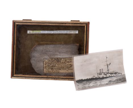A section of salvaged timber form the Royal Navy battleship HMS 'Victoria', circa 1892,   mounted with manuscript label. 'Fro