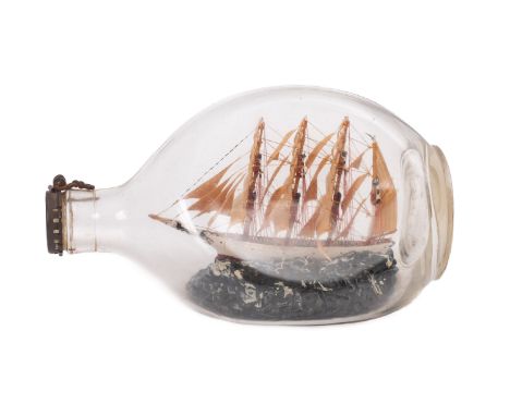 An early 20th Century model ship in bottle of the four masted barque 'Herzogin Cecile'. Set within a Haigs bottle and set at 
