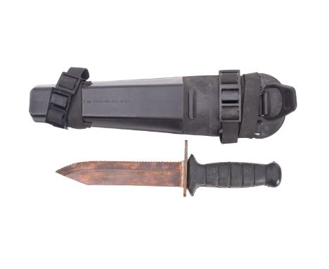 A Royal Navy NATO pattern Non-magnetic diving knife, with single edge and saw back blade and rubber grip in a black plastic s