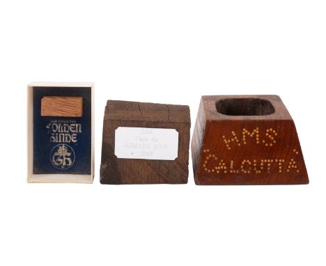 A teak inkwell from the timbers of HMS 'Calcutta', together with a section of timber with inscribed plaque 'Oak from an Armad