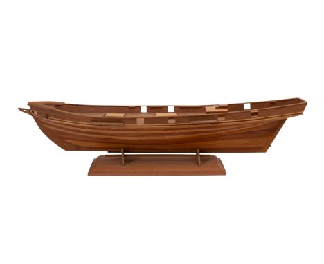 A scratch built plank and pin wooden hull. Having wooden deck fittings and set on a wooden stand, 15cm high, 68cm long, 17cm.