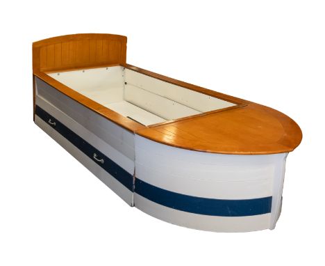 A contemporary wooden single bed in the form of a boat. Having a simulated plank top finished in white with blue to the 'wate
