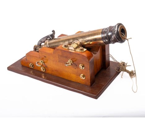 An 19th Century steel and brass line throwing cannon. Having a bronze barrel, trunnions and projectile, mounted on a wooden c