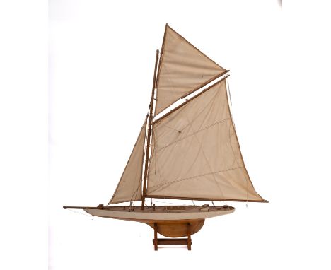 A 20th Century gaff rigged pond yacht. Fully rigged over simulated plank deck with deck house and fittings, wooden plank pinn