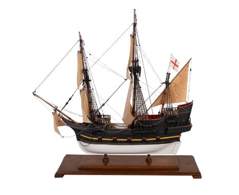 A scale model of a 10 gun merchant ship, shown fully rigged above a simulated plank deck with fittings on a plank and pinned 
