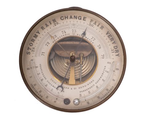 An early 20th century brass aneroid barometer for 'Charles J Gaupp & Co, Hong Kong', central visible drum and mechanism surro