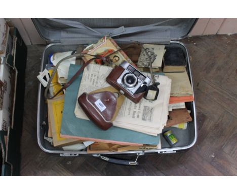 A suitcase containing a large quantity of black and white photos, mainly family, a 1937 canned reel of Kodak cine film plus a