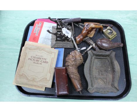 A mixed lot including three cigarette card albums, vintage foreign bank notes, a carved wooden walking stick finial of a man 