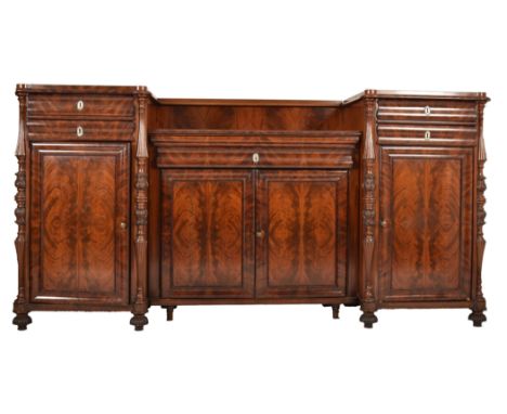 A 19th century Victorian inverted breakfront flame mahogany sideboard credenza / buffet. The sideboard having twin pedestals 