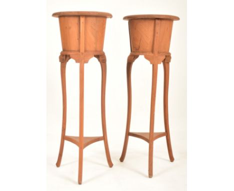 A pair of Edwardian early 20th century fruitwood floor jardinieres / planters on tripod stands. each jardiniere having a flar