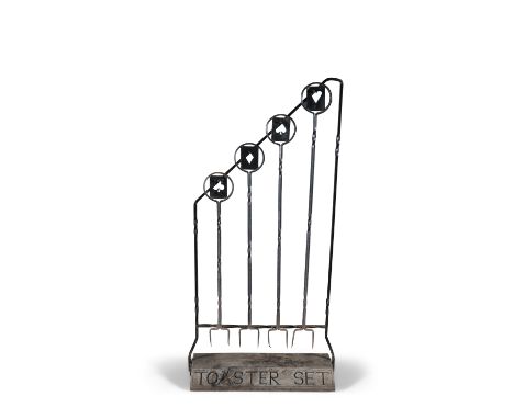 A SET OF FOUR WROUGHT IRON TOASTING SET, comprising four two-pronged toasting forks, each with playing card motifs, on fitted