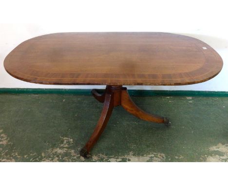 Georgian Oval Mahogany Snap Top Breakfast Table with turned centre column on 3 sabre supports with brass castors & toe caps, 