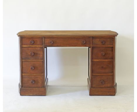 An American mahogany kneehole desk, wide frieze drawer with label verso made by Maddox Table, Jamestown New York, the two arc