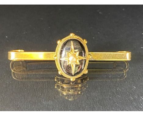 Victorian Mourning Brooch on 9ct Gold Bar set with seed Pearl in starburst design on black enamel 