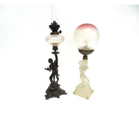 A BRONZED METAL FIGURAL CANDLESTICK  modelled as a putti on naturalistic base, stamped 'F Souchal Paris', adapted to oil lamp