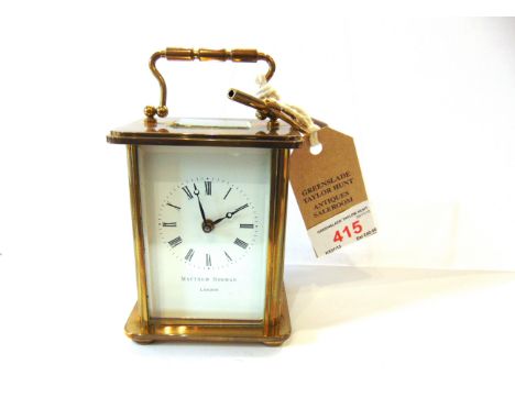 A BRASS CASED CARRIAGE CLOCK  with Swiss movement, the enamel dial with Roman numerals inscribed 'Matthew Norman London', 14c