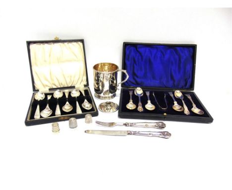 A SILVER MUG a cased set of six silver teaspoons, with tongs; a cased set of six silver teaspoons; a child's knife and fork; 