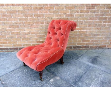 A BUTTON UPHOLSTERED NURSING CHAIR,  on turned and carved mahogany supports with brass casters