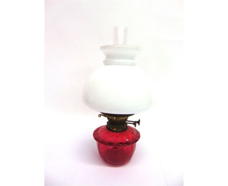 A VICTORIAN OIL LAMP FITTING,  with cranberry glass reservoir and opaque glass shade, 40cm high including glass funnel, the s