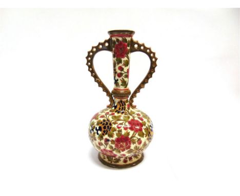 A TWIN HANDLED VASE IN THE MANNER OF ZSOLNAY PECS, of bulbous form with elongated neck and twin pierced handles, decorated wi