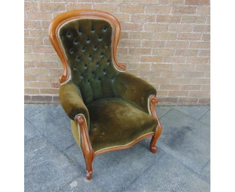 A VICTORIAN BUTTON UPHOLSTERED ARMCHAIR  with show wood frame, on carved cabriole supports