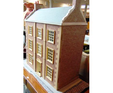 A GEORGIAN STYLE DOLL'S HOUSE the side-hinged front elevation opening to reveal an internal arrangement of six rooms, with ha