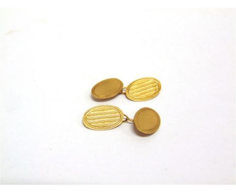 A PAIR OF 9CT GOLD CUFFLINKS the oval plain panel chain linked to an engine turned oval panel, 3.6g gross