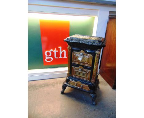 A FRENCH CAST IRON AND ENAMEL WOODBURNING STOVE,  52cm wide 39cm deep 81cm high