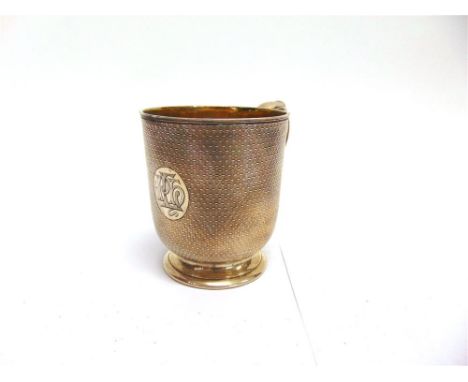 A VICTORIAN SILVER CHRISTENING MUG by Robert Garrard, London, 1846, the engine turned body, with monogrammed circular cartouc