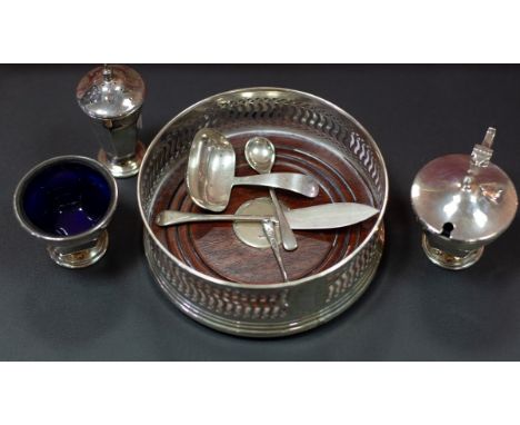 A silver wine coaster, W I Broadway & Co., Birmingham 1994, a silver three-piece cruet set, Alexander Clark & Co Ltd., Birmin