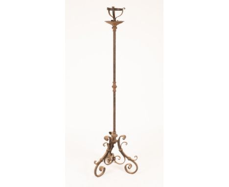 A wrought iron floor standing pricket candlestick on scroll tripod base, 164cm high/Provenance: Spetchley Park, Worcestershir