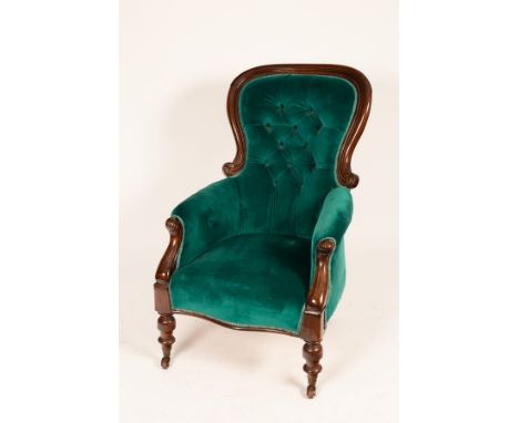 A mahogany armchair with deep button back, on turned front legs, 102cm CONDITION REPORT: Loose on frame, upholstery stained i