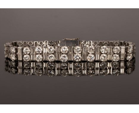 A mid 20th Century diamond bracelet by Cartier, platinum set with a graduated row of baguette and brilliant cut diamonds, ind