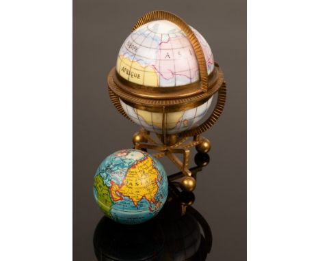 An etui in the form of a gilt metal mounted globe and stand, fitted gilt metal mounted children's accessories and another gui