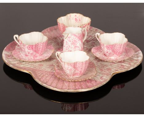 A pink shell moulded tea service, Wileman & Co., pattern 92158 Rg 60650, comprising three teacups and saucers, a milk jug, a 