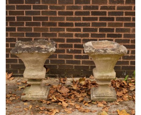 A pair of weathered stone garden vases, square with fluted tapering form, on pedestal bases, 40cm high CONDITION REPORT: Very