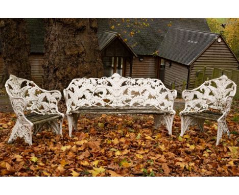 A suite of Coalbrookdale style fern ware garden furniture, comprising a pair of chairs 65cm wide and a settle 152cm wide/see 