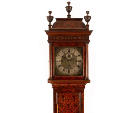 A Maple &amp; Co. longcase clock, the hood with three urn finials, the 12" square brass dial with silver engraved chapter rin