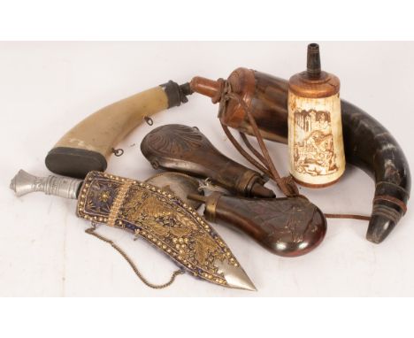 Two embossed copper powder flasks, two other powder flasks, a large horn powder flask, a dagger and a helmet badge CONDITION 