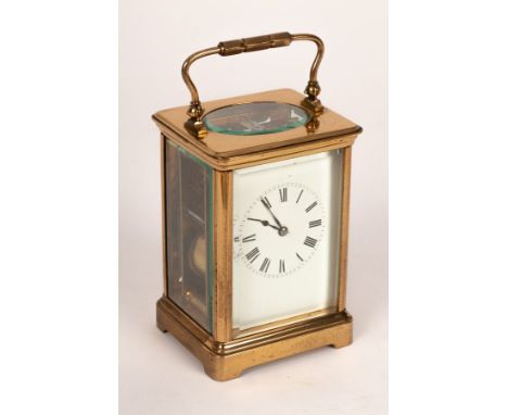 A gilt cased eight-day carriage clock with white enamel dial, striking on a gong, 19cm high/see illustration CONDITION REPORT