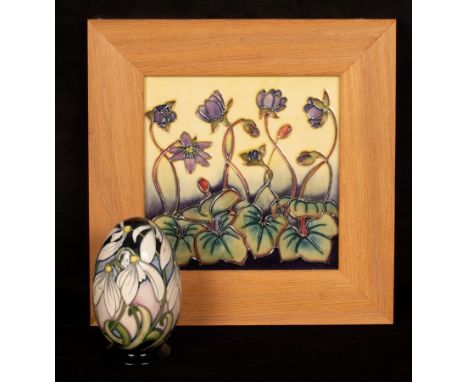 A framed Moorcroft tile, 15cm x 15cm and a Moorcroft egg, 11cm high/Provenance: Spetchley Park, Worcestershire CONDITION REPO
