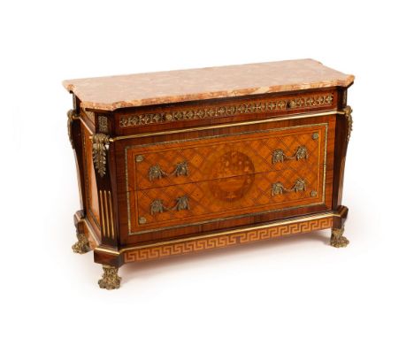 A Louis XVI style gilt metal mounted commode, the marble top above a frieze drawer and two further inlaid drawers on paw feet