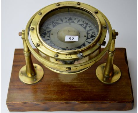 BRASS CASED SHIPS COMPASS ON WOODEN STAND BY KELVIN & HUGHES LTD
