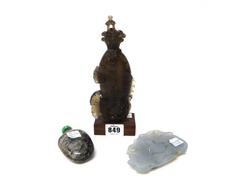 A Chinese smokey brown quartz bottle and stopper, probably 19th century, in the form of a leaping fish, the cover formed as w