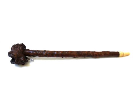A large rootwood opium pipe, 19th century, the naturalistic bulbous bowl carved subtly all over with Buddha figures and anima
