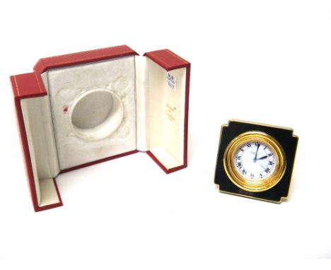 A Cartier Paris gilt metal and simulated green lacquer shaped square cased alarm clock, the signed white dial with black Roma